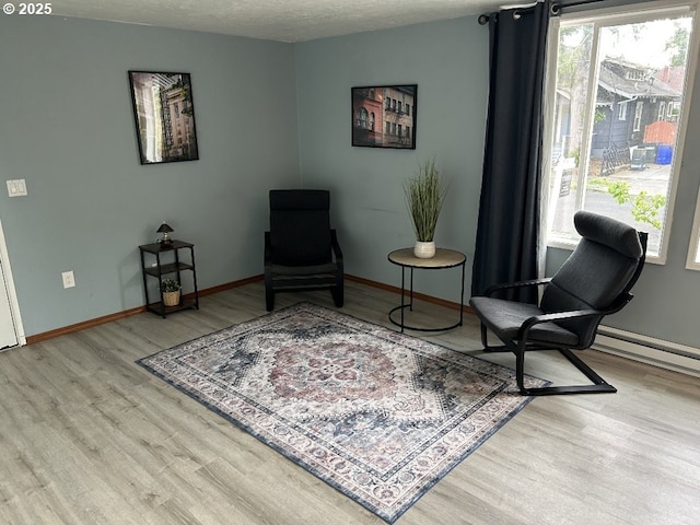 living area with wood finished floors and baseboards