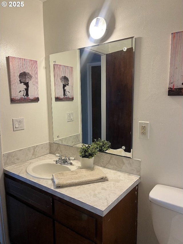 half bath with vanity and toilet
