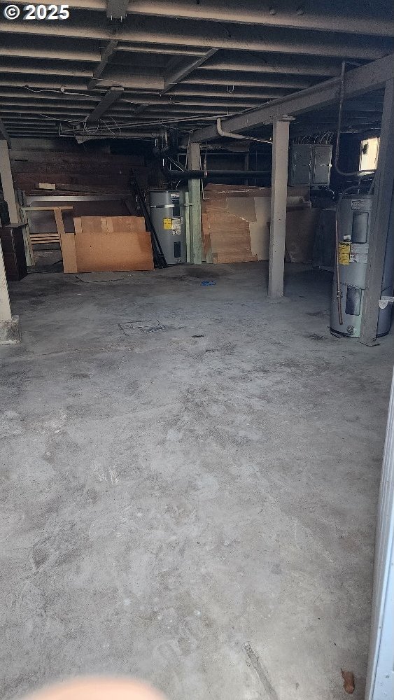 unfinished basement featuring water heater and heating unit