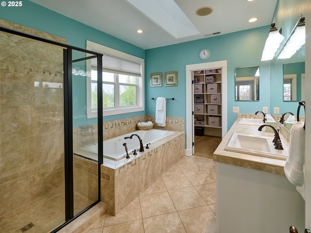 bathroom featuring a sink, a garden tub, a shower stall, and tile patterned floors