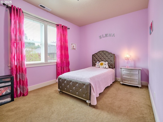 carpeted bedroom featuring visible vents and baseboards