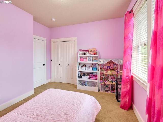 bedroom featuring carpet flooring, a closet, and baseboards