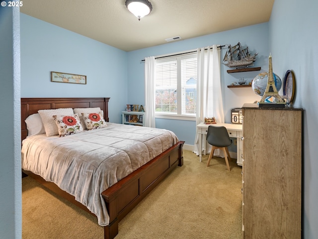 bedroom with carpet floors, baseboards, and visible vents