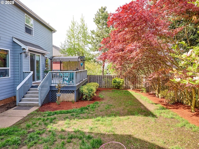 view of yard with a fenced backyard and a deck