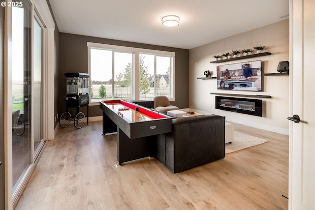 game room with light wood finished floors and baseboards