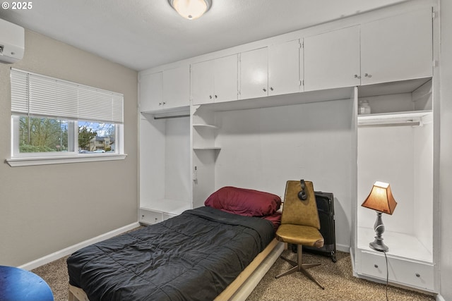 bedroom with a wall mounted AC and light colored carpet