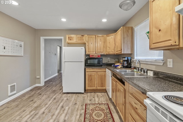 kitchen with sink, light brown cabinetry, white appliances, and light wood-type flooring