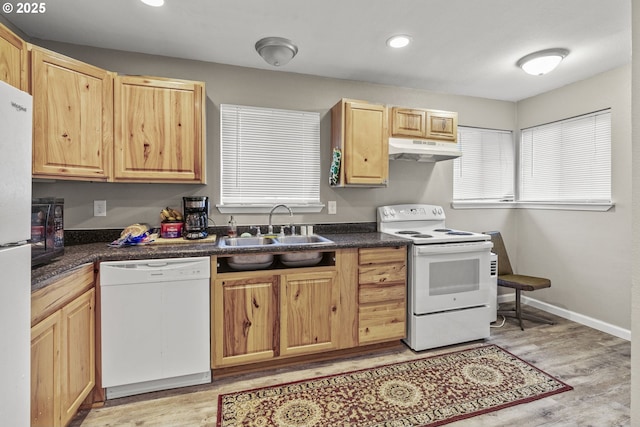 kitchen featuring sink, white appliances, light brown cabinets, and light hardwood / wood-style floors