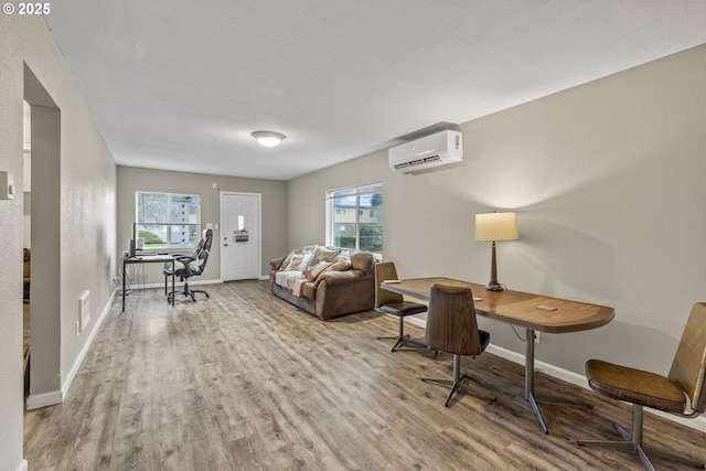 interior space with light hardwood / wood-style floors and an AC wall unit