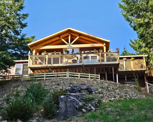 back of house with a deck and fence