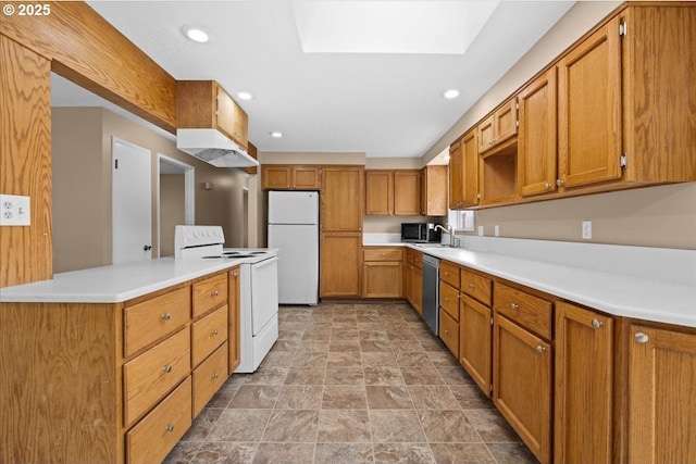 kitchen featuring a skylight, white appliances, brown cabinets, and under cabinet range hood