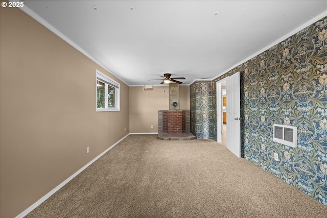 unfurnished living room featuring a fireplace, visible vents, ornamental molding, carpet flooring, and baseboards