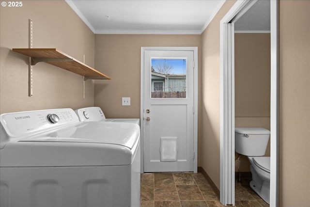 washroom featuring laundry area, washing machine and dryer, baseboards, and crown molding