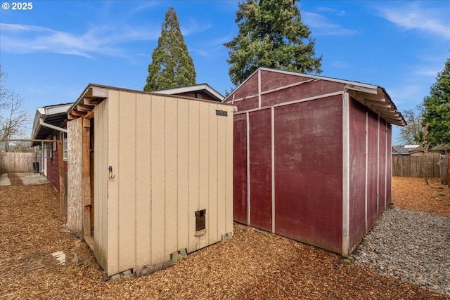 view of shed featuring fence