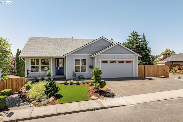 13212 SE Terra Cascade Dr, Happy Valley, OR 97086 - view of front of house with a garage, driveway, covered porch, roof with shingles, and board and batten siding