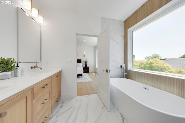 13212 SE Terra Cascade Dr, Happy Valley, OR 97086 - ensuite bathroom featuring a freestanding bath, double vanity, and marble finish flooring