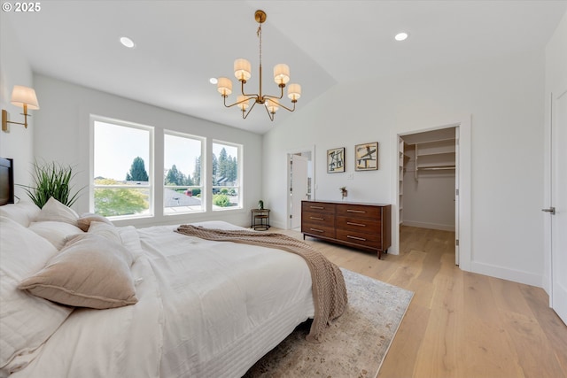 13212 SE Terra Cascade Dr, Happy Valley, OR 97086 - bedroom featuring a chandelier, vaulted ceiling, a spacious closet, light wood finished floors, and baseboards