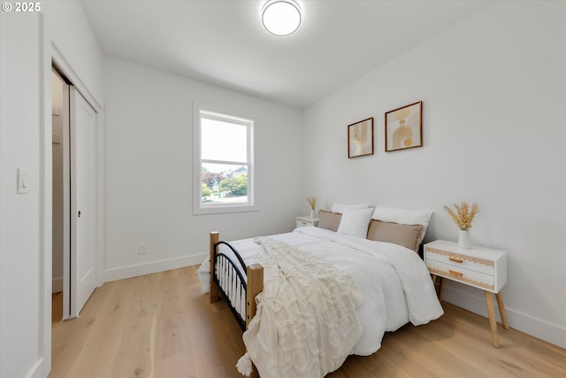 13212 SE Terra Cascade Dr, Happy Valley, OR 97086 - bedroom with light wood-style flooring, baseboards, and a closet