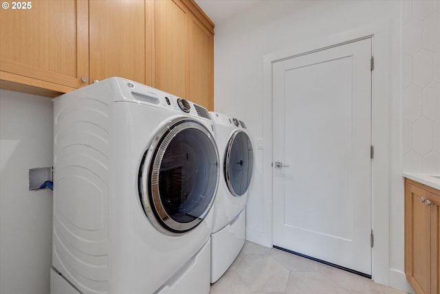 13212 SE Terra Cascade Dr, Happy Valley, OR 97086 - washroom featuring cabinet space, washer and dryer, and light tile patterned floors