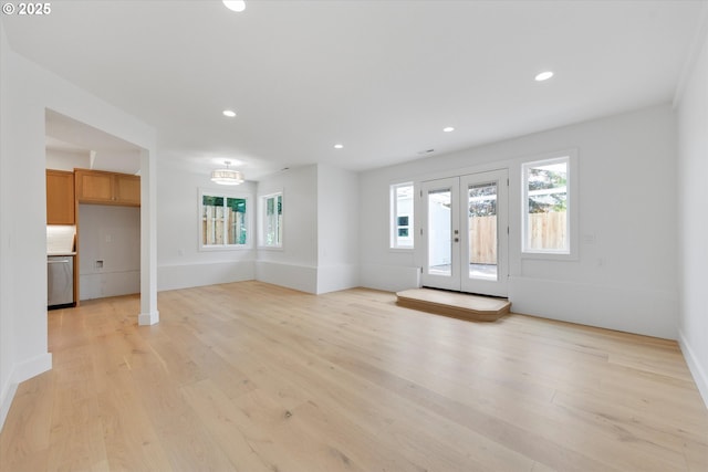 13212 SE Terra Cascade Dr, Happy Valley, OR 97086 - unfurnished living room featuring plenty of natural light, light wood finished floors, recessed lighting, french doors, and baseboards