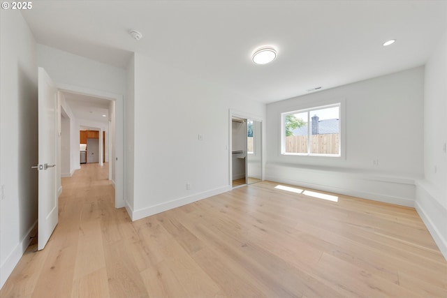 13212 SE Terra Cascade Dr, Happy Valley, OR 97086 - unfurnished bedroom featuring light wood finished floors, baseboards, a closet, and recessed lighting