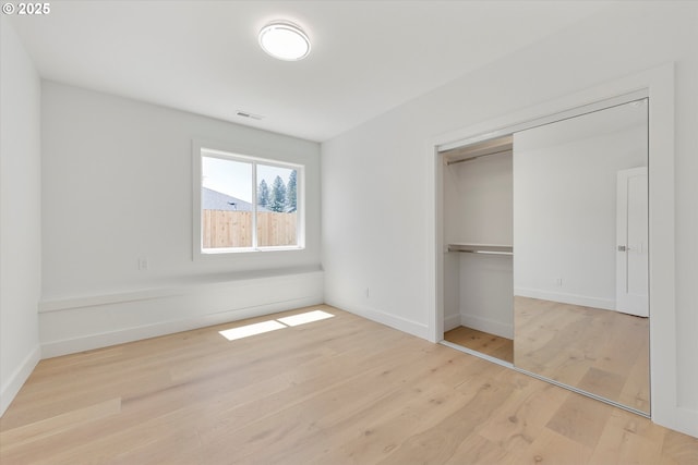 13212 SE Terra Cascade Dr, Happy Valley, OR 97086 - unfurnished bedroom with wood finished floors, baseboards, and a closet