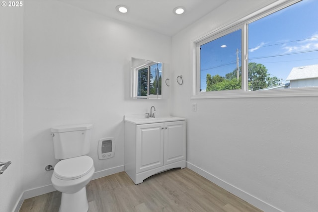 115 E Sheridan St, Newberg, OR 97132 - bathroom with vanity, wood finished floors, heating unit, and recessed lighting
