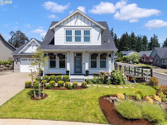 14897 Rooster Rock Ave NE, Aurora, OR 97002 - craftsman-style house featuring board and batten siding, concrete driveway, an attached garage, covered porch, and a front yard