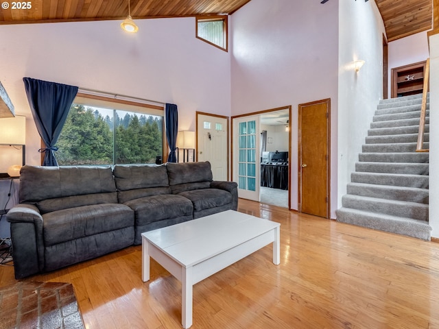 living area featuring stairway, wood ceiling, lofted ceiling, and wood finished floors