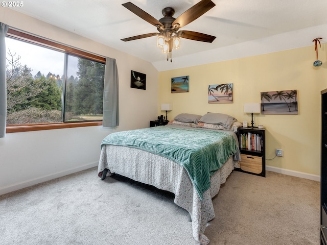 carpeted bedroom featuring vaulted ceiling, a ceiling fan, and baseboards