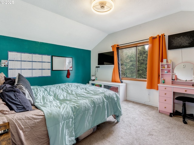 bedroom with baseboards, lofted ceiling, and carpet floors