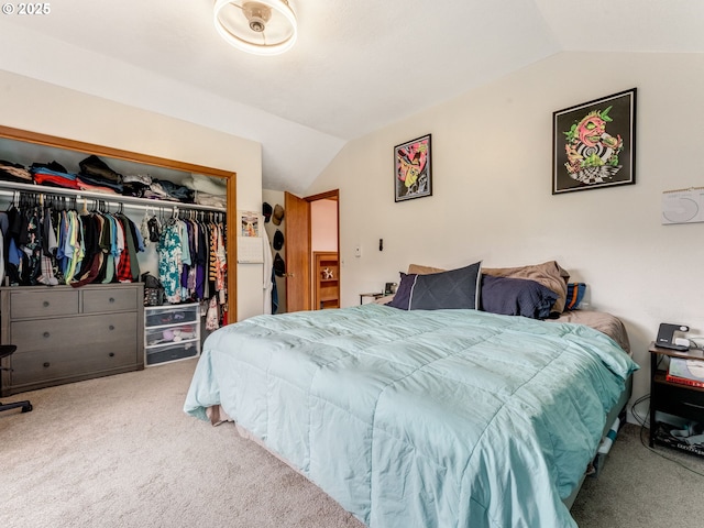 carpeted bedroom with a closet and lofted ceiling