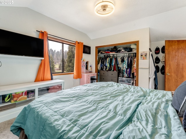 carpeted bedroom featuring a closet and lofted ceiling