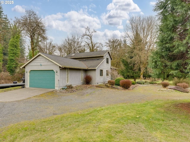 view of front of property with driveway, an attached garage, a front yard, and a shingled roof