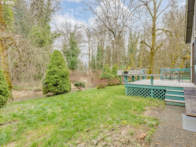 view of yard with a wooden deck