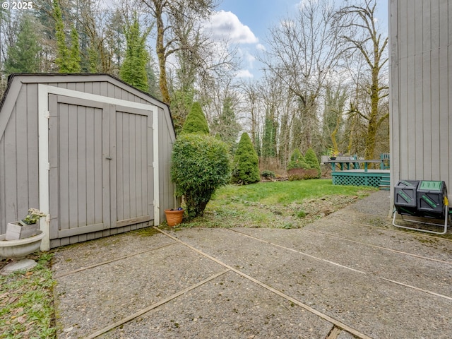 exterior space with an outbuilding, a shed, and a wooden deck