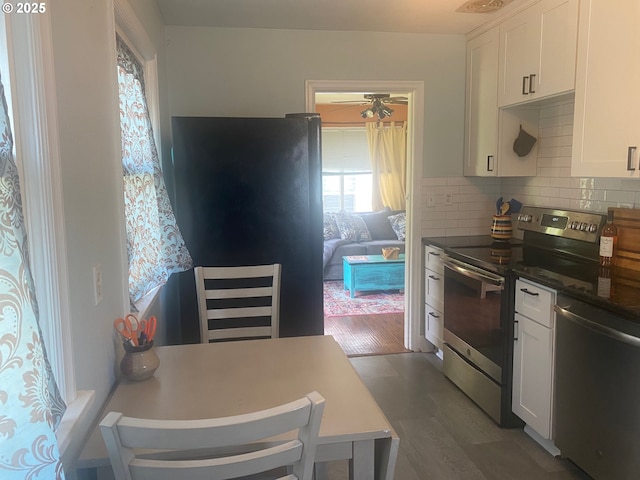 3802 C St, Washougal, WA 98671 - kitchen with stainless steel appliances, white cabinets, and decorative backsplash