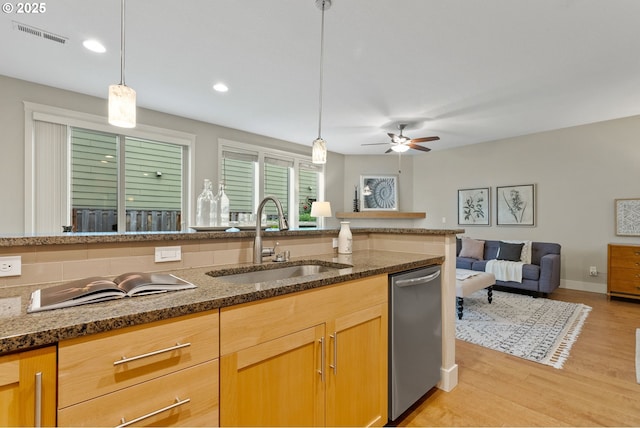 16185 NW Ashfield Dr, Beaverton, OR 97006 - kitchen with a sink, dishwasher, dark stone counters, light wood-style flooring, and a ceiling fan