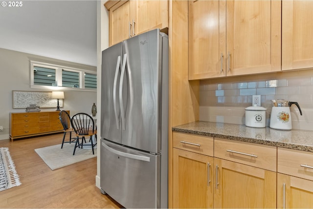16185 NW Ashfield Dr, Beaverton, OR 97006 - kitchen featuring freestanding refrigerator, light brown cabinets, light wood finished floors, backsplash, and light stone countertops