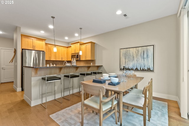 16185 NW Ashfield Dr, Beaverton, OR 97006 - dining room featuring baseboards, light wood finished floors, and recessed lighting