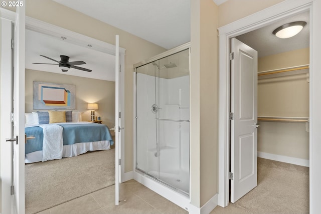 16185 NW Ashfield Dr, Beaverton, OR 97006 - ensuite bathroom featuring a shower stall, a ceiling fan, a spacious closet, and baseboards