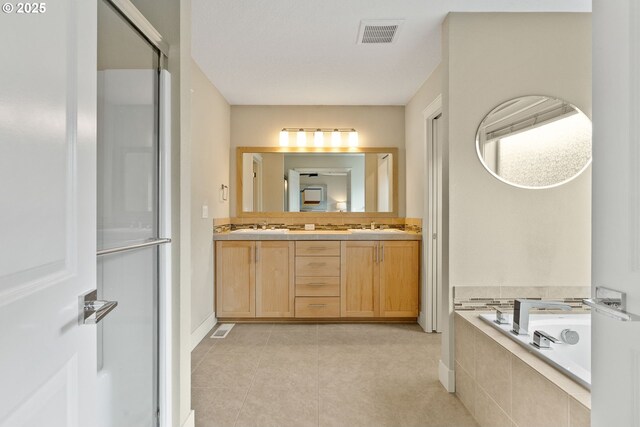 16185 NW Ashfield Dr, Beaverton, OR 97006 - bathroom with a garden tub, double vanity, tile patterned flooring, and a shower with shower door