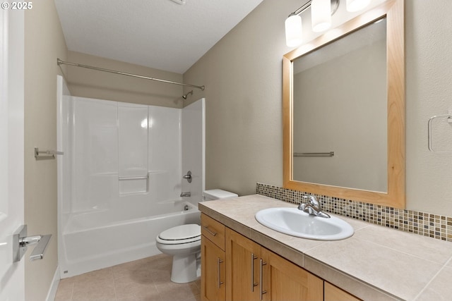 16185 NW Ashfield Dr, Beaverton, OR 97006 - bathroom featuring toilet, vanity, tub / shower combination, tile patterned flooring, and baseboards