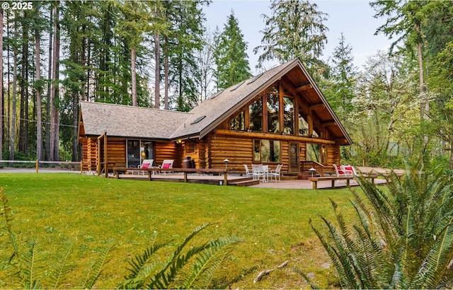 89935 Greenwood Dr, Leaburg, OR 97489 - back of property with a patio area, a shingled roof, a yard, and log exterior