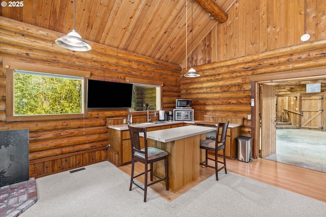 89935 Greenwood Dr, Leaburg, OR 97489 - kitchen featuring a center island, a sink, wood ceiling, light countertops, and beam ceiling
