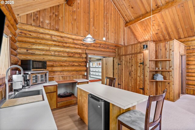 89935 Greenwood Dr, Leaburg, OR 97489 - kitchen with rustic walls, light countertops, wooden ceiling, a sink, and refrigerator