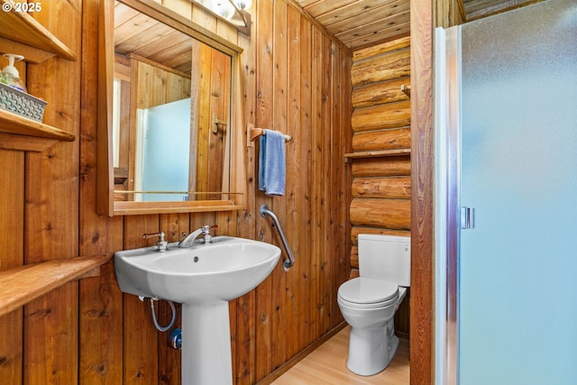 89935 Greenwood Dr, Leaburg, OR 97489 - bathroom with a sink, toilet, log walls, wood finished floors, and wooden ceiling