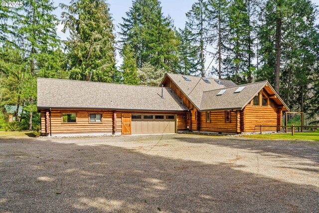89935 Greenwood Dr, Leaburg, OR 97489 - view of front of house with aphalt driveway, roof with shingles, log siding, and a garage