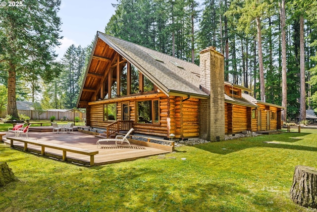 89935 Greenwood Dr, Leaburg, OR 97489 - rear view of property featuring a chimney, fence, log siding, a wooden deck, and a lawn