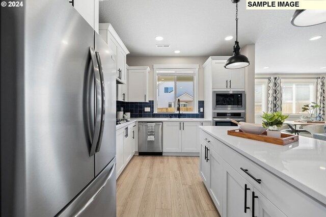 8510 NE 134th Ave Lot 87, Vancouver, WA 98685 - kitchen featuring appliances with stainless steel finishes, plenty of natural light, white cabinetry, backsplash, and recessed lighting